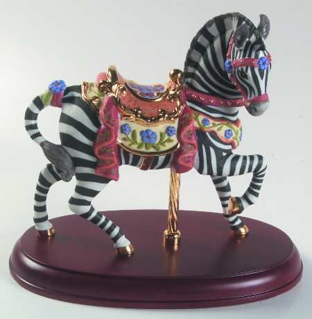 a zebra figurine is on top of a wooden stand with a red base