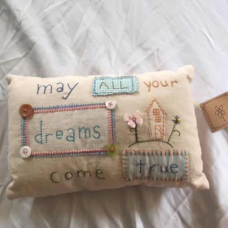 a pillow that has some buttons on it and the words may all your dreams come