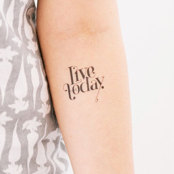 a woman's arm with the words live today tattooed in black ink on it