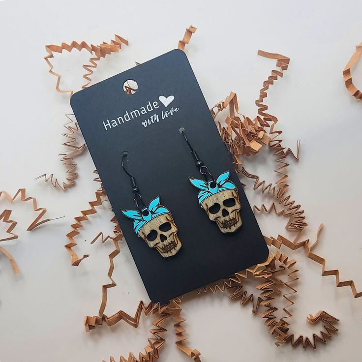 Introducing our edgy and stylish skull-shaped earrings adorned with a vibrant bandana, the perfect accessory for those who embrace the spooky side of life. Available in striking purple, bold blue, or classic black bandanas, these earrings add a touch of Halloween flair to any ensemble. Whether you're shopping for a skull enthusiast or simply seeking a unique gift for her, these earrings are sure to make a statement. Embrace the spirit of the season with our spooky yet chic earring gifts, perfect for adding a dash of personality to any outfit. Trendy Halloween Earrings As A Gift, Trendy Halloween Earrings For Gift, Quirky Blue Jewelry For Gifts, Quirky Blue Jewelry For Gift, Casual Halloween Jewelry Gift, Punk Skull Print Earrings For Gift, Punk Skull Print Earrings Gift, Punk Style Skull Print Earrings As Gift, Casual Skull Jewelry For Gifts