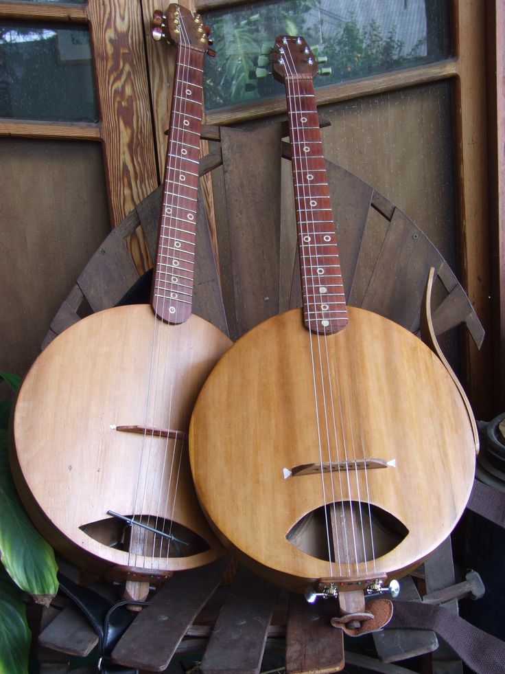 two guitars are sitting on top of each other