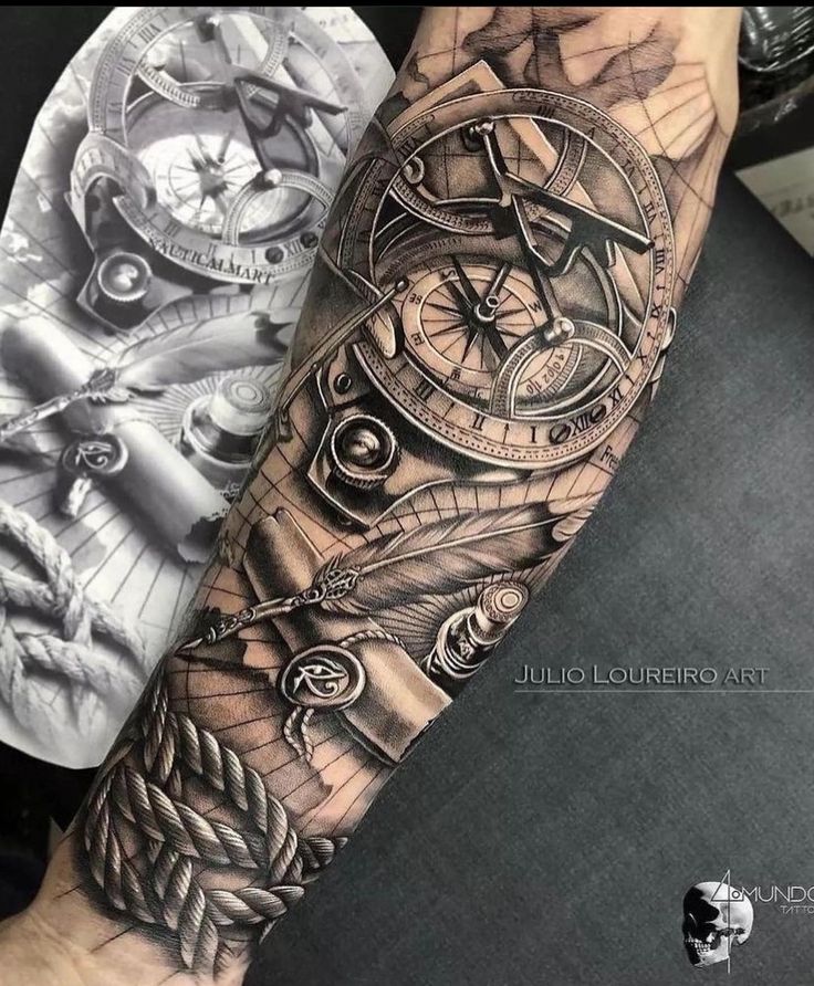 a man's arm with a clock and feathers tattoo on it