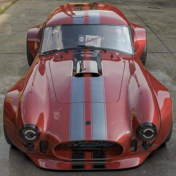 a red sports car parked on top of a parking lot