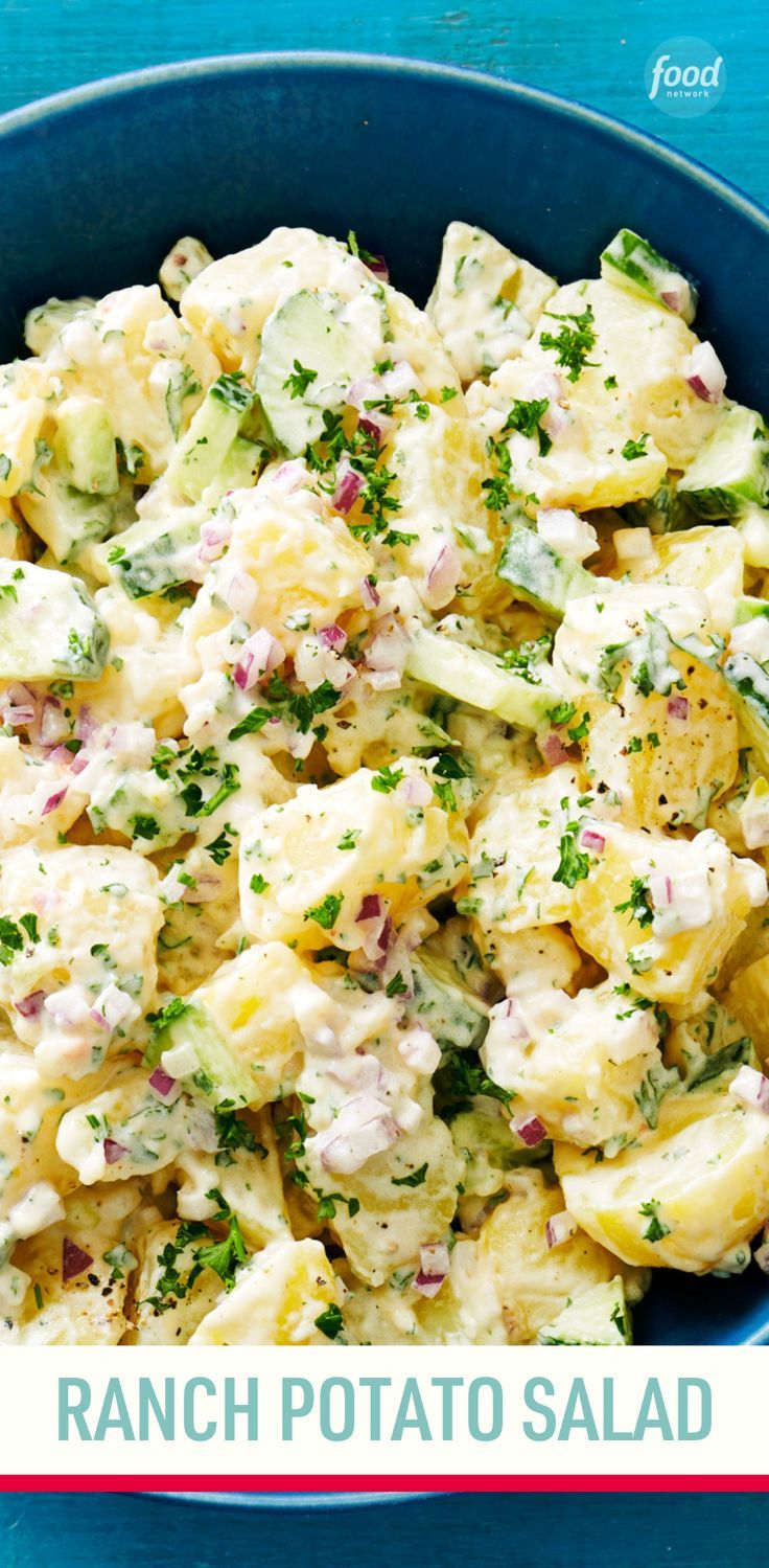 a blue bowl filled with potato salad on top of a blue tablecloth and the words ranch potato salad above it