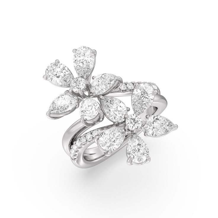 a white gold and diamond ring with leaves on the front, surrounded by smaller diamonds