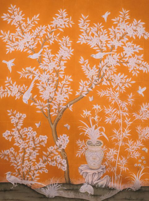 an orange wall with white flowers and birds on it