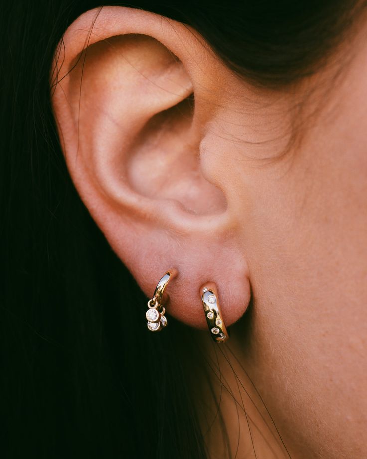 A pair of Diamond huggie earringsfeature a small, close-fitting hoop that is adorned with diamonds, adding a touch of elegance and sparkle to the overall design. The term "huggie" comes from the snug fit of the earring against the earlobe. These earrings are favored for their comfortable fit and ability to add a touch of glamour without being overly flashy. They are a popular choice for those who want a more refined and close-fitting hoop earring adorned with the timeless beauty of diamonds. Pro 14k Gold Huggie Cartilage Earrings With Diamond Accents, Tiny White Gold Huggie Jewelry, Tiny White Gold Huggie Earrings, Sterling Silver Tarnish-resistant Huggie Diamond Earrings, Dainty 14k Gold Dangle Huggie Earrings, Tiny Hoop Huggie Earrings For Anniversary, Tiny Round Huggie Earrings For Anniversary, Tiny 14k Gold Huggie Earrings, Tiny Yellow Gold Huggie Jewelry