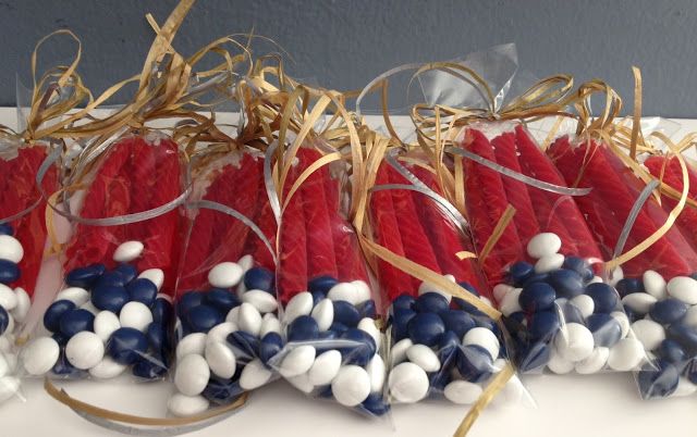 red, white and blue candies are wrapped in clear cellophane with gold ribbon