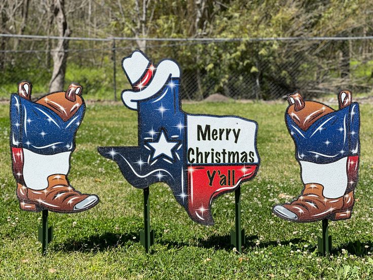 three christmas yard signs with cowboy boots on them