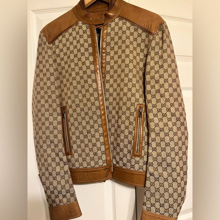 The Gg Motif Is A Subtle Nod To The Theme Of Reinvention That Appears Throughout The House's Narrative. First Used In The '70s, The Monogram Is An Evolution Of The Gucci Rhombi Designa Pattern From The '30s Archives. A Part Of The Aria Collection, It Appears Atop This Jacket With Leather Trims. Minor Signs Of Wear. Original Price: $ 4,500 Fitted Beige Gucci Outerwear, Gucci Designer Leather Outerwear, Gucci Fitted Leather Jacket For Fall, Fitted Gucci Beige Outerwear, Designer Leather Gucci Outerwear, Designer Gucci Leather Outerwear, Casual Fitted Gucci Outerwear, Gucci Brown Winter Outerwear, Gucci Beige Outerwear For Fall