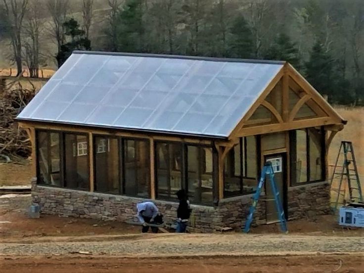 two men are working on a small house