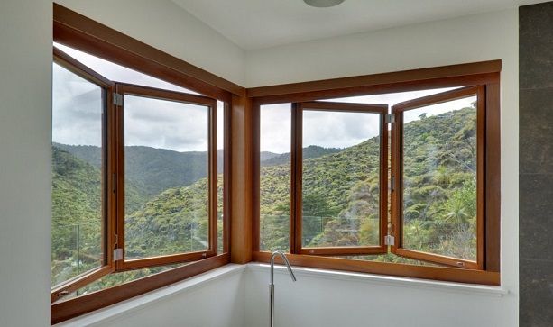 a bathroom with three windows overlooking the mountains