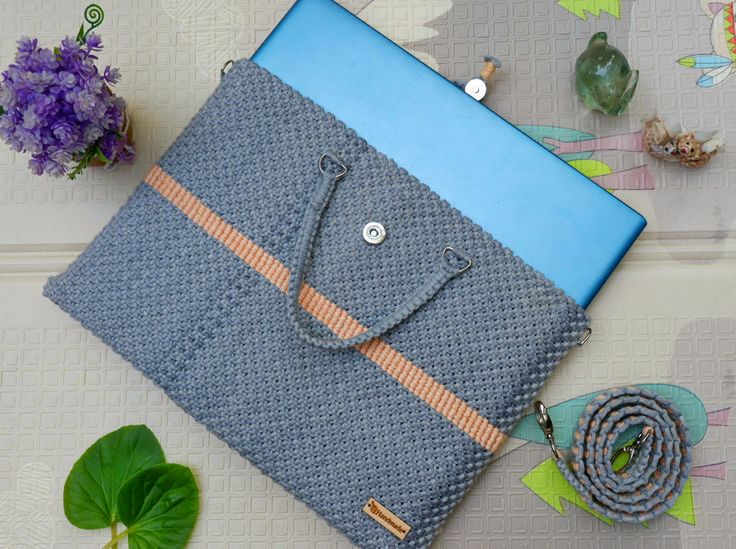 a blue and orange case sitting on top of a table next to some purple flowers