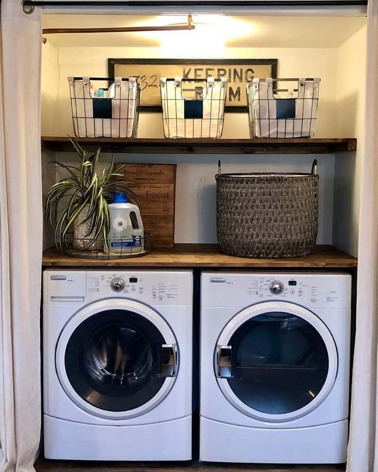 a washer and dryer in a small room with open shelving above them