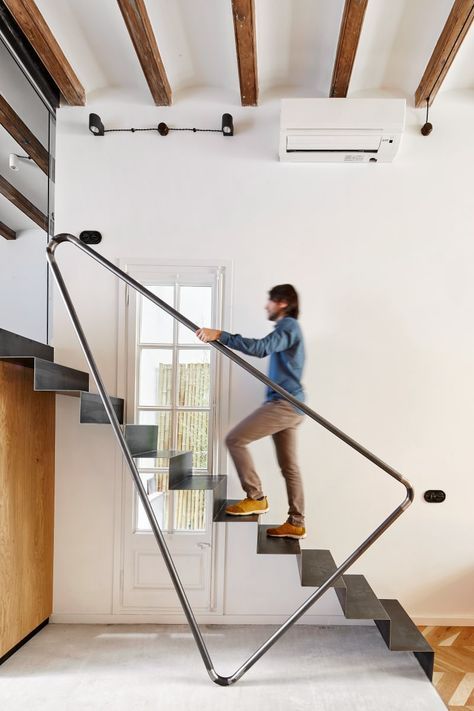 a man is climbing up the stairs in his house