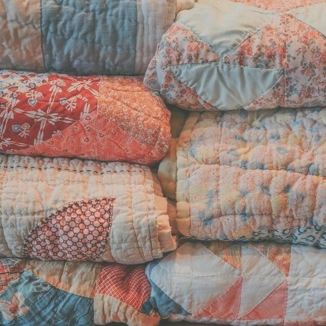 a pile of quilts stacked on top of each other