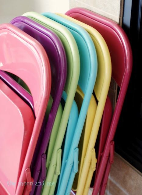 a stack of colorful chairs sitting next to each other