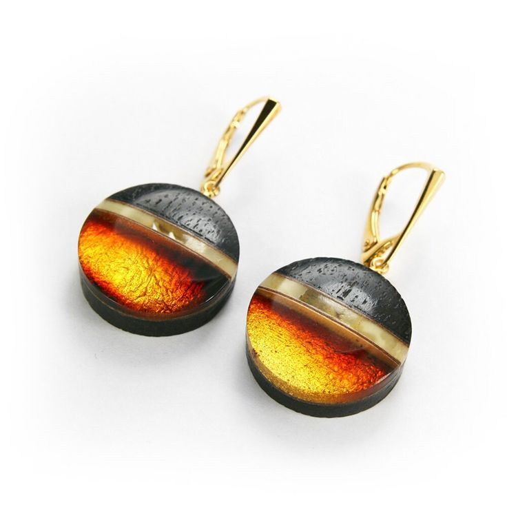 Round earrings, dangling, hand-made from selected Baltic amber, high-purity silver gilded with 24-carat gold, gold leaf under amber and precious wood. The offered jewelry was handcrafted in my studio in Gdynia - Galeria Bursztyn Tadeusz Dobkowski. Completely Polish product. As the various shapes and colors are individual features of natural Baltic amber, individual elements may slightly differ from the presented pattern, maintaining its character. Materials: Baltic Amber (about 40 million years) 925 sterling silver, gold-plated with 24 carat gold 23 carat gold leaf under amber Black Oak (certified for 1400 years)   Earrings dimensions: Length with a hook: 40mm Length without earwires: 20mm Width: 20mm Height: 7mm Weight: 5.2g    We attach to the purchase: Certificate of Authenticity Decora Gold Round Pendant Earrings For Formal Events, Gold Round Pendant Earrings For Formal Occasions, Modern Round Clip-on Earrings For Gift, Modern Round Clip-on Earrings As Gift, Modern Round Pendant Earrings As Gift, Modern Baltic Amber Jewelry For Formal Occasions, Modern Formal Baltic Amber Jewelry, Modern Amber Drop Earrings, Luxury Amber Drop Earrings