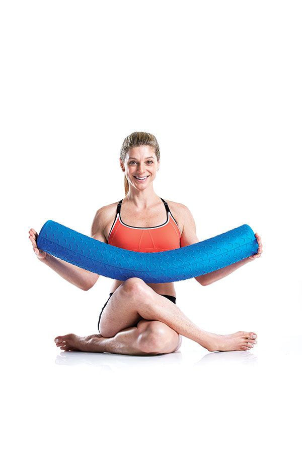 a woman sitting on the floor with an inflatable object