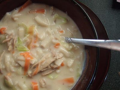 a brown bowl filled with soup on top of a table