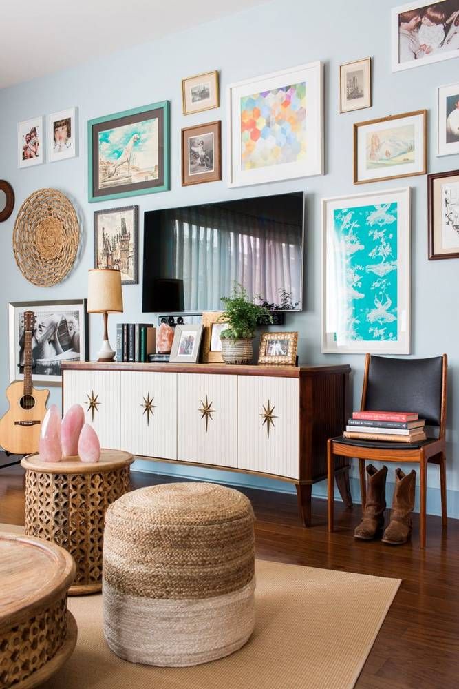 a living room filled with furniture and lots of pictures on the wall above it's entertainment center