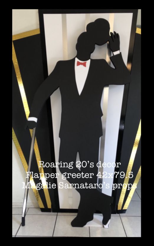 a paper cut out of a man in a tuxedo and bow tie holding a cane