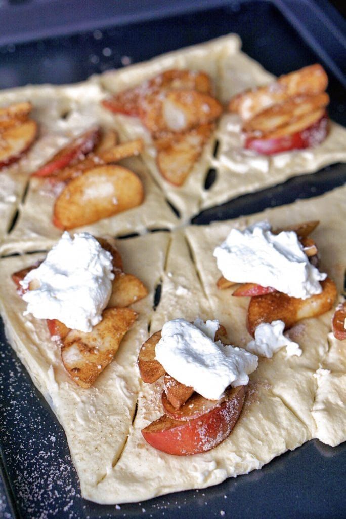 four pieces of pizza with toppings on them sitting on a tray in the oven