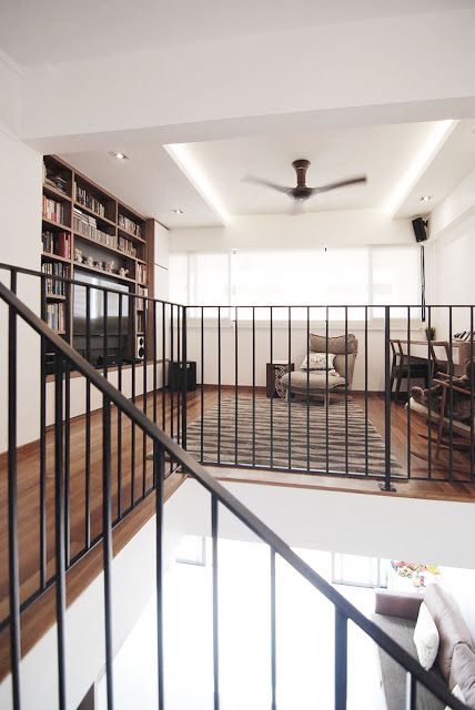 a living room filled with furniture and a metal railing