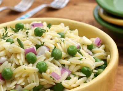 a yellow bowl filled with rice and peas