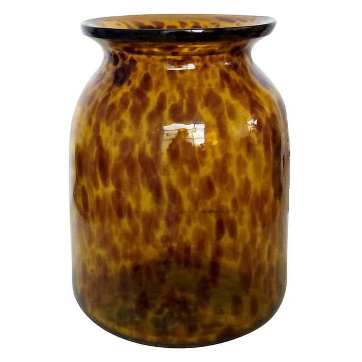 a brown vase sitting on top of a white table