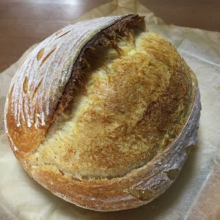 a loaf of bread sitting on top of a piece of wax paper