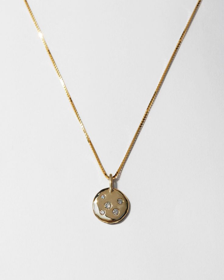 A versatile and customizable talisman. The Amada Necklace was originally created to mark my daughter's 6th birthday. I set a small gold pendant with both of our birthstones (and an extra diamond, just for luck!) and have worn it as a symbol of our bond ever since. The Amada Necklace is available with lab created diamonds, or can be customized with the birthstones of your choice to commemorate the ones you love. Diamonds in the 5 stone pendant measure 1.5, 1.75, 2, 2.25 and 2.5 mm. Cast in solid Yellow Gold Medallion Necklace With Si Clarity, Tarnish Resistant Yellow Gold Birthstone Pendant Necklace, Engraved Yellow Gold Birthstone Pendant Necklace, Yellow Gold Round Birthstone Necklace, Tarnish Resistant, Yellow Gold Tarnish Resistant Birthstone Necklace, Spiritual Yellow Gold Sterling Silver Birthstone Necklace, Yellow Gold Tarnish-resistant Birthstone Necklace, Small Gold Pendant, 6th Birthday