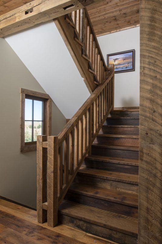 a wooden staircase leading up to a window