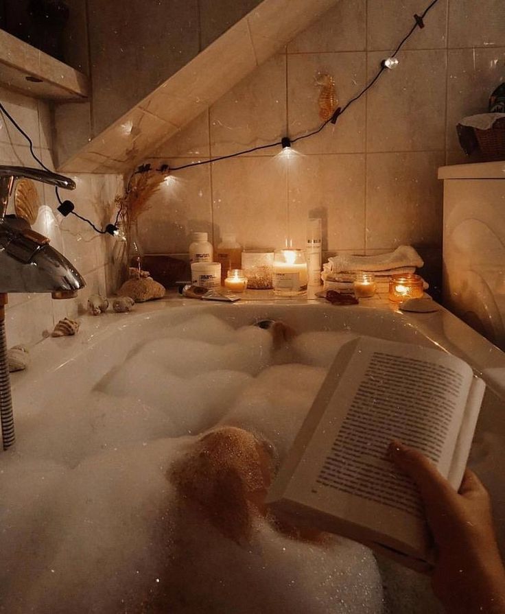 a person is reading a book in the bathtub