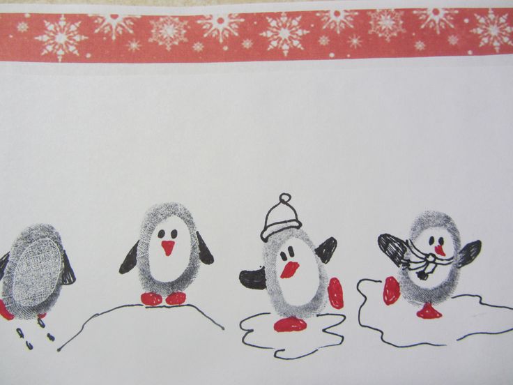 three little penguins in the snow with a santa hat on and one penguin wearing a scarf