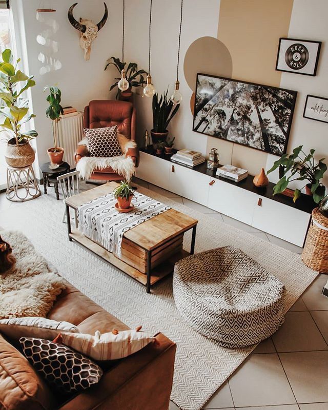 a living room filled with furniture and plants