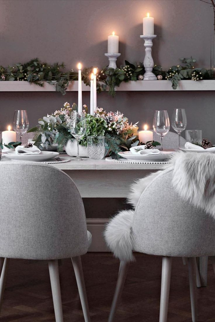 a dining room table with candles and flowers on it