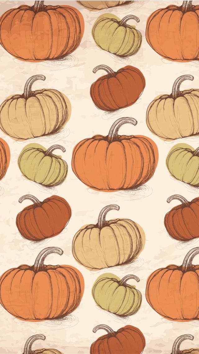 a bunch of pumpkins sitting on top of a white surface with orange and green ones