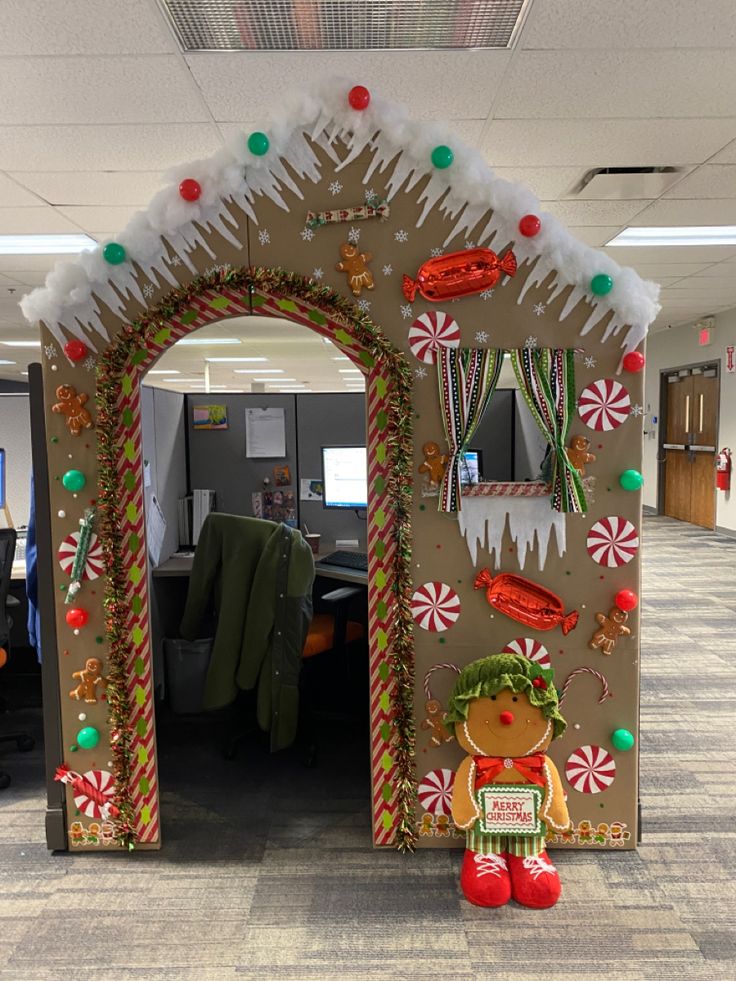 an office cubicle decorated for christmas with gingerbreads, candy canes and decorations