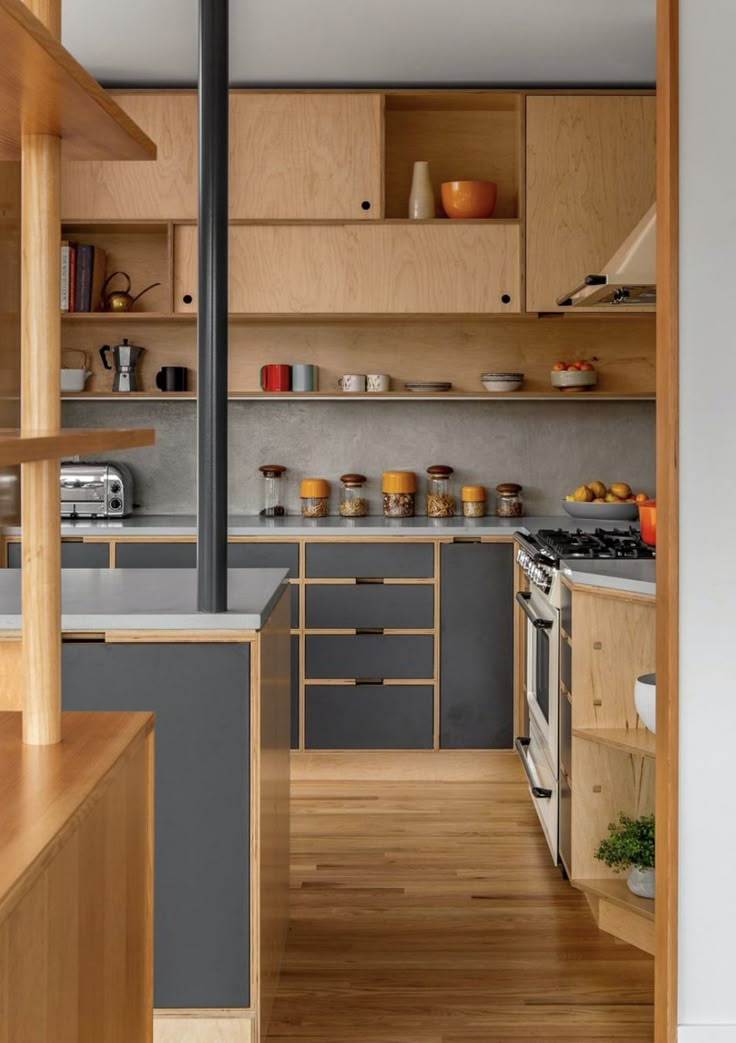 an open kitchen with wooden cabinets and wood flooring