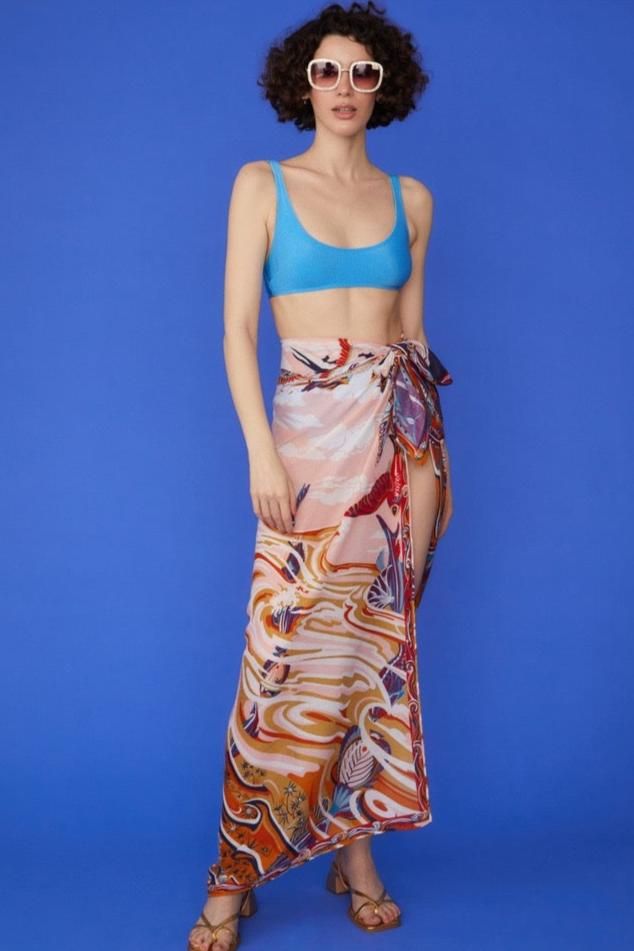 Wrap yourself in luxury with our Multi Tie-Waist Sarong, a versatile piece that exudes tropical elegance. Crafted from a sumptuous blend of cashmere, silk, and cotton, this sarong offers an incredibly soft touch while maintaining a lightweight, airy feel. The vibrant tropical print transports you to paradise, while the contrast hem adds a chic, defined edge. Designed with a flexible tie-waist, this one-size-fits-all sarong is perfect for beach days, poolside lounging, or adding a stylish layer t Summer Silk Printed Bottoms, Versatile Summer Wrap Bottoms, Multicolor Silk Sarong For Beach, Bohemian Silk Bottoms For Summer, Bohemian Silk Sarong, Elegant Silk Sarong For Beach, Silk Sarong For Beach Spring Season, Elegant Wrap Sarong For Summer, Elegant Summer Wrap Sarong