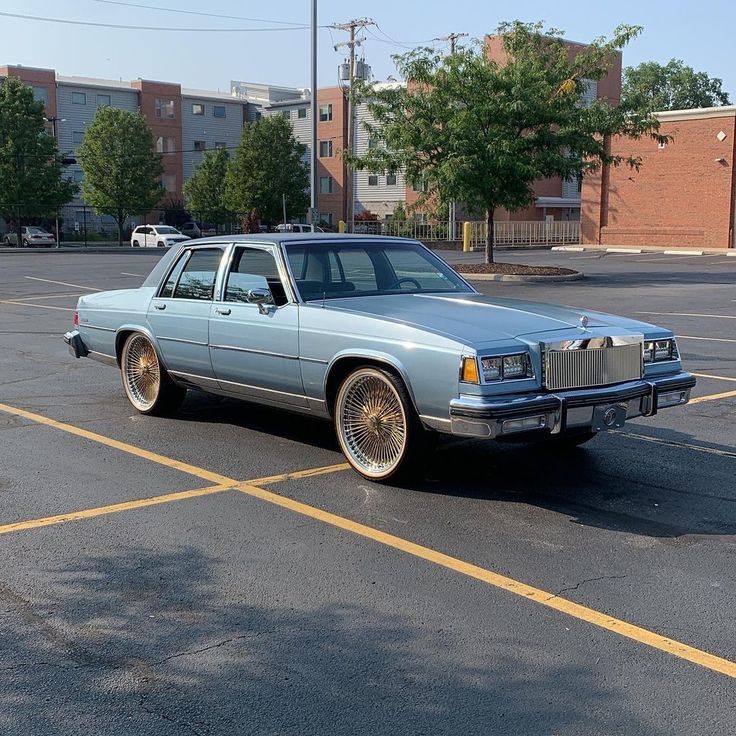 a blue station wagon parked in a parking lot