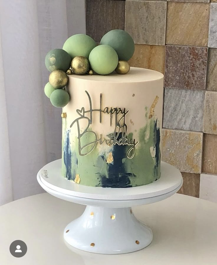 a birthday cake with green and gold decorations