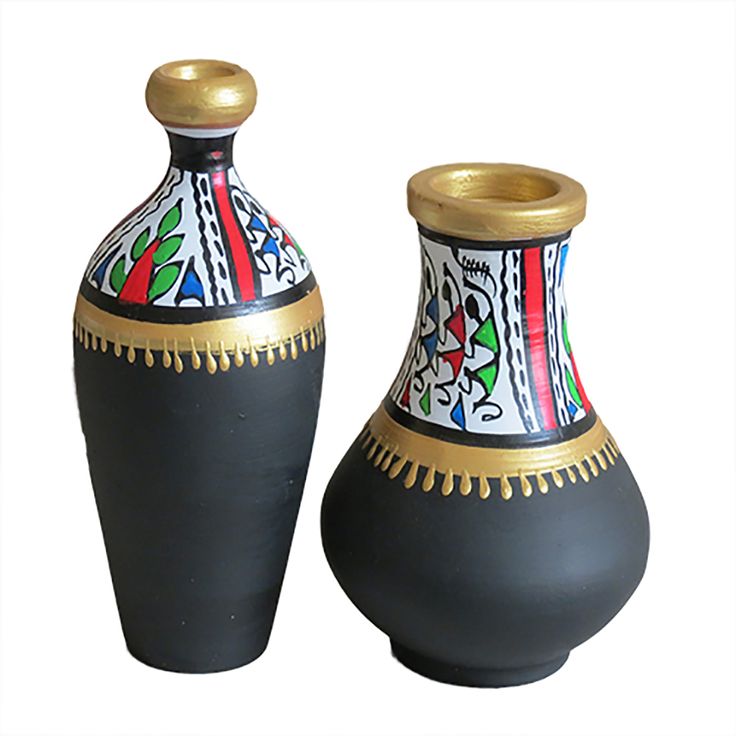 two black and gold vases sitting side by side on a white background, one is decorated with colorful designs