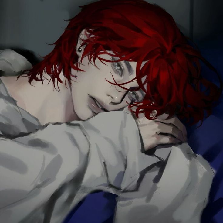 a woman with red hair laying on top of a bed