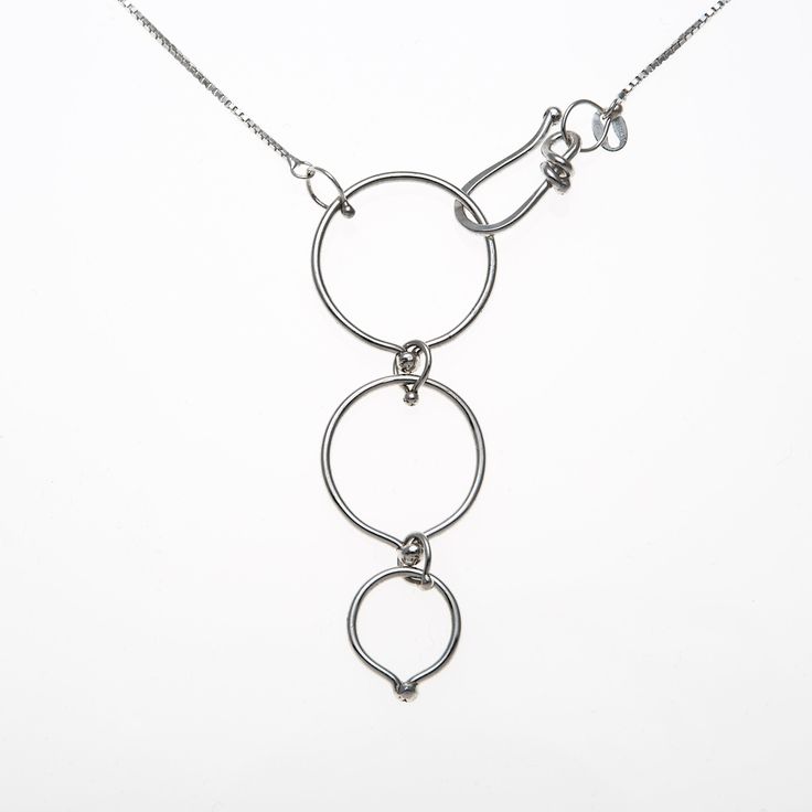 "Stone(s): N/A Material(s): Pendant and box chain are high polished sterling silver (.925).  Pendant/Chain Measurement(s): Pendant is 2.0\" long and 3/4\" wide. Box chain is included, available in the following lengths: 16,\" 18,\" or 20.\"  Description/Artist Notes: This versatile necklace can be worn two different ways.   Style 1 (Y-Design): Hook the clasp on the largest loop for a longer neckline, with the pendant oriented vertically. Style 2 (Continuous): Hook the clasp on the smallest loop Silver Lariat Stainless Steel Jewelry, Modern Sterling Silver Link Jewelry, Silver Lariat Necklace In Stainless Steel, Modern Silver Chain Jewelry With Round Pendant, Silver Stainless Steel Lariat Necklace, Modern Lariat Silver Chain Jewelry, Modern Silver Chain Lariat Jewelry, Modern Silver Lariat Chain Jewelry, Modern Sterling Silver Chain Necklaces