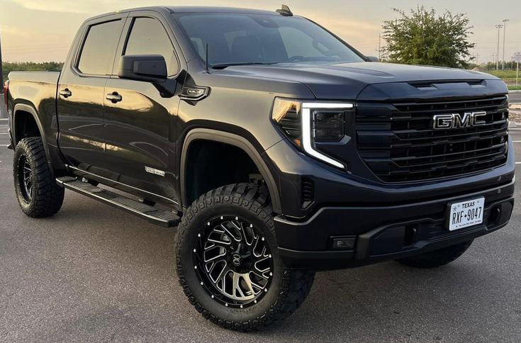 a black truck parked in a parking lot