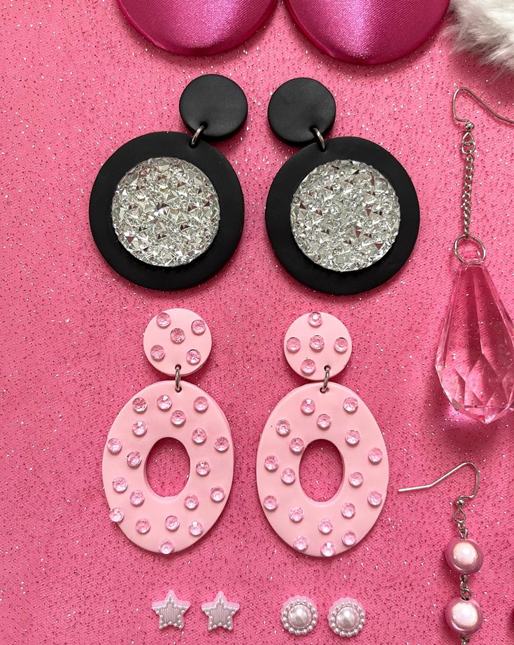 This collection is one of four doll-inspired jewelry collections! This one is glam! The fancy little group of earrings was 100% inspired by fancy nights out on the town. Of course, in a gorgeous gown! The styles are: Large Fabric Stud Earrings - 2" in Diameter Black Clay Earrings with Large Rhinestone - 2.5" Long, 1.625" Wide Pink Clay Oval Mod Hoop Earrings with Pink Rhinestones - 2.625" Long, 1.5" Wide Pink Chandelier Dangle Earrings (In Order from Left to Right): #1. 3.75" Long, .625" Wide. # Whimsical Party Jewelry With Matching Earrings, Whimsical Handmade Earrings For Party, Handmade Party Chandelier Drop Earrings, Whimsical Drop Earrings For Party, Whimsical Dangle Earrings For Party, Handmade Pink Earrings For Evening, Handmade Pink Evening Earrings, Trendy Handmade Chandelier Earrings For Party, Whimsical Black Earrings For Party