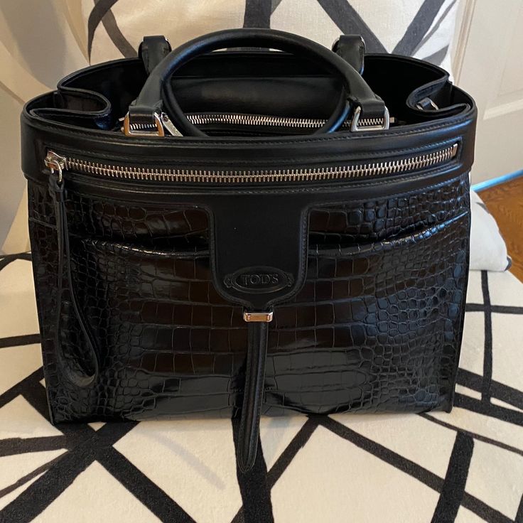 Tod’s Black Handbag With Crocodile Stamped And Plain Leather, 13” X 10” X 6”, Handle 5” Drop, Optional Shoulder Strap 33”-41” Long, 2 Exterior Pockets 1 Zippered, Side Snaps, 2 Zippered Interior Pocket, Pristine Condition, No Wear, Very Structured Black Satchel With Detachable Handle For Business Trips, High-end Travel Bags With Crocodile Pattern, Luxury Bags For Business Trips With Silver-tone Hardware, High-end Crocodile Pattern Travel Bags, Designer Black Shoulder Bag With Crocodile Pattern, Luxury Black Bags With Crocodile Pattern, Designer Shopping Bags With Crocodile Pattern, Designer Crocodile Pattern Bags For Shopping, Designer Crocodile Pattern Shopping Bags