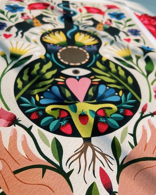 a close up of a table cloth with flowers and birds on it, in the shape of a peacock